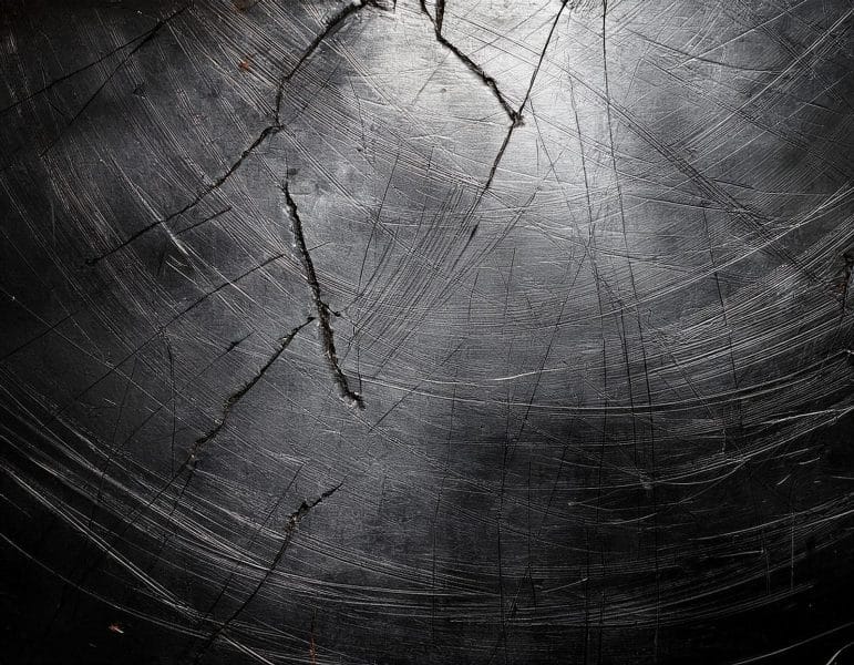 Hydrogen embrittlement can be caused by corrosion, electrochemical reactions, mechanical stresses, and other environmental conditions, resulting in cracks in the metal.